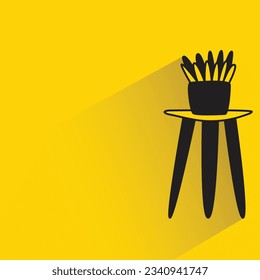 plant pot on table with shadow on yellow background