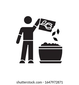 Planting flower seeds black glyph icon. Propagating houseplants. Plant growing process, stage. Indoor gardening. Putting seeds in soil. Silhouette symbol on white space. Vector isolated illustration