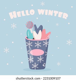 Plastic cup of coffee with snowflakes ornament, lollipop and sweet hearts. Hello winter quote. Greeting card.