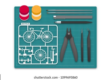 Plastic Model With Tool Kit On Cutting Mat, Bicycle Concept Design Illustration Isolated On White Background With Copy Space