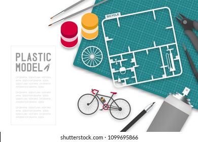 Plastic model with tool kit on cutting mat, bicycle concept design illustration isolated on white background with copy space