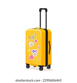 Plastic yellow suitcase with cute stickers isolated on white background.