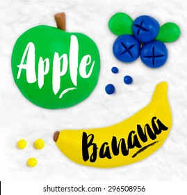 Plasticine modeling fruits apple, banana, blueberries, cobbled together on a white background