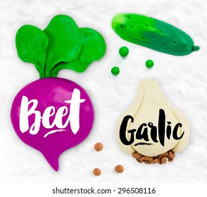 Plasticine modeling vegetables beet, garlic, cucumber cobbled together on a white background