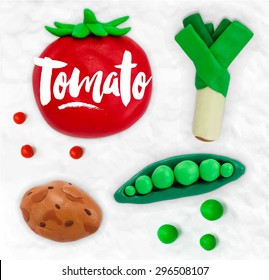 Plasticine modeling vegetables tomato, peas, leek, potato cobbled together on a white background