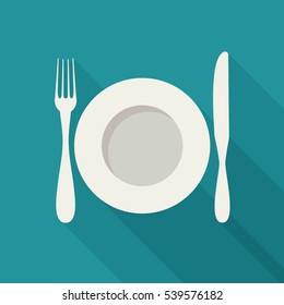 Plate with cutlery and long shadows