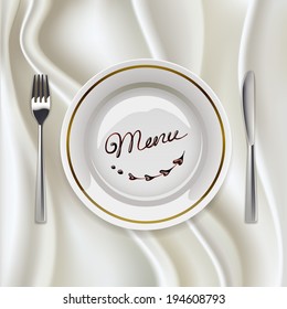 Plate with fork and knife on glossy tablecloth