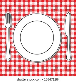 Plate, fork and knife on tablecloth