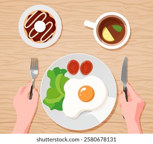 Plate with fried egg, tomato and greens, chokolate donut and tea. Fork and knife. Top view of food. Cafe for healthy and tasty breakfasts. A full breakfast early in the morning. English breakfast.