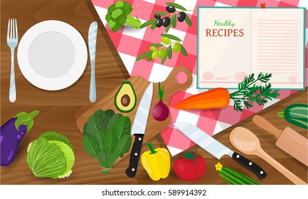 plate knife and fork on a red tablecloth in a cage. Cooking concept. Groceries on wooden table