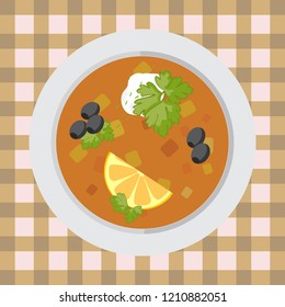 A plate of pickle soup on the table with a tablecloth