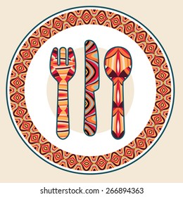 Plate, spoon, knife and fork with ethnic ornaments. Isolated on light background