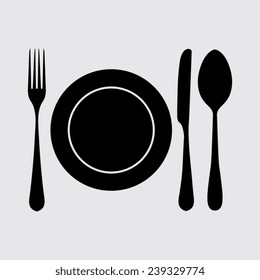plate with spoon, knife and fork on a grey background