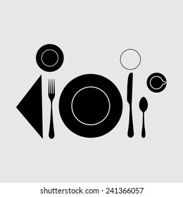 plate with spoon, knife and fork  on a grey background