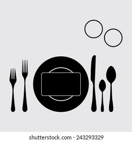 plate with spoon, knife and fork on a grey background