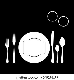 plate with spoon, knife and fork on a black background
