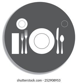 plate with spoon, knife and fork on a grey background