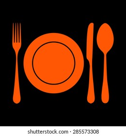 plate with spoon, knife and fork on a black background
