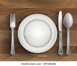 Plate spoon knife and fork on wood