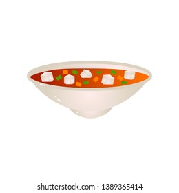 Plate of vegan soup dish with carrot and green peas