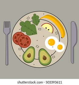 A plate with vegetables and eggs with a knife and fork