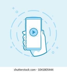 Play icon on smartphone screen. Hand holding smartphone. Modern vector outline object.