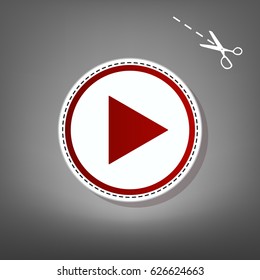 Play sign illustration. Vector. Red icon with for applique from paper with shadow on gray background with scissors.