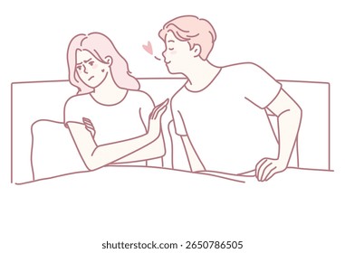A playful couple is sharing a tender moment in bed, beautifully showcasing their intimacy and deep connection