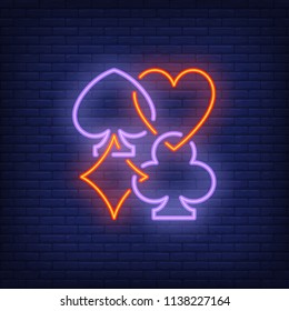 Playing card suits neon sign. Diamond, club, heart, spade. Night bright advertisement. Vector illustration in neon style for gambling, casino and poker club