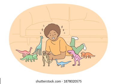 Playing with dinosaurs toys concept. Smiling boy lying on floor at home and playing games with colourful toys reptiles dinosaurs. Education and learning with developing games for children 