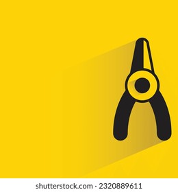 pliers with shadow on yellow background