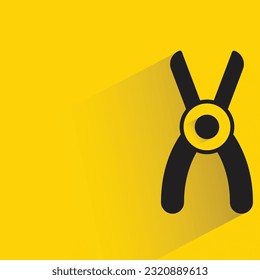 pliers with shadow on yellow background