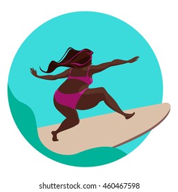 Plus size surfing girl catching a wave.