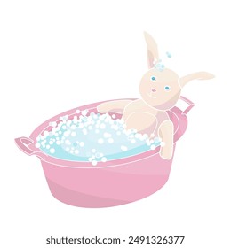 Plush bunny is lying in soapy suds in a  basin getting washed