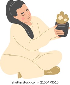 Plus-size girl takes care of a houseplant.