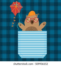 Pocket detail with a cute little teddy bear playing with a red kite. T-shirt apparel print graphics. Original graphics for checkerd fabric