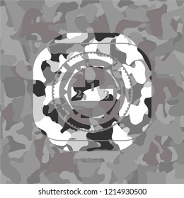 podium icon inside grey camouflaged emblem
