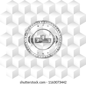 podium icon inside grey emblem with geometric cube white background