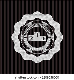 podium icon inside silver emblem