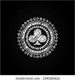 poker clover icon inside chalk emblem written on a blackboard