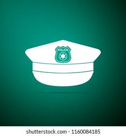 Police cap with cockade icon isolated on green background. Police hat sign. Flat design. Vector Illustration