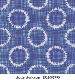 Polka dot ring tie dye seamless pattern. Hand dyed effect wax batik style all over print circle. Spliced streaks of gradient dye gingham check background. Bleach resist blended texture geo effect. 