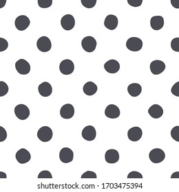 Polka dot seamless pattern. Black hand drawn dots on white