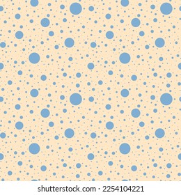 Polka dot seamless pattern. Chaotic blue circle shape on yellow background
