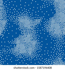 Polka dot seamless pattern gathered in clusters on a blue background