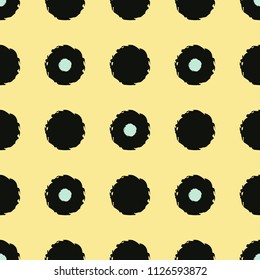 Polka dot seamless pattern with grunge shapes. Fashion circles in black and mint green colors on yellow background. Usable as print for textile, cover, wrapping paper etc.