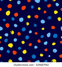 Polka dot seamless pattern. Hand drawn artistic ink circles. Orange, yellow, green dots on blue background. Design element for textile and wrapping paper