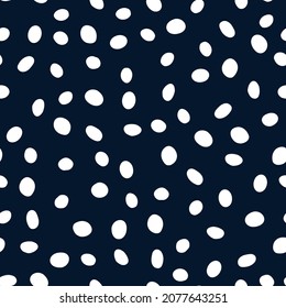 Polka dot seamless repeat pattern. Random placed, irregular vector spots all over surface print on dark blue background.