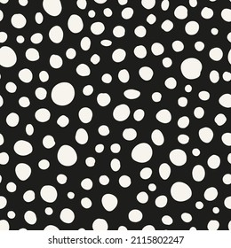 Polka dot seamless repeat pattern. Random placed, irregular vector spots all over surface print on black background.