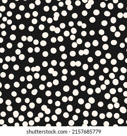 Polka dot vector monochrome seamless pattern. Irregular chaotic white spots, circles on black background. Simple abstract minimal texture. Repeat design for print, cover, wallpaper, decor, packaging